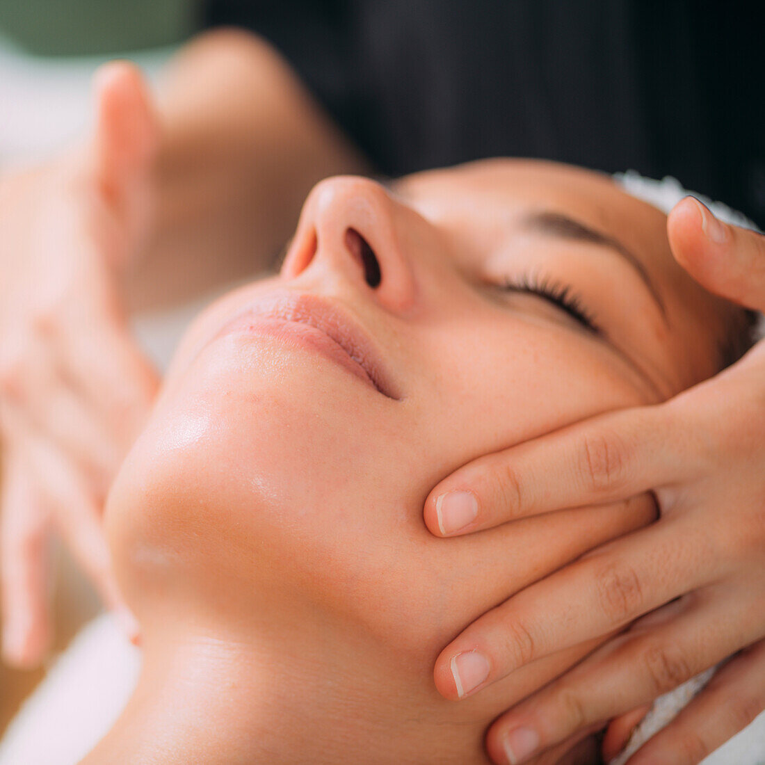 Enjoying ayurvedic facial massage with essential oils