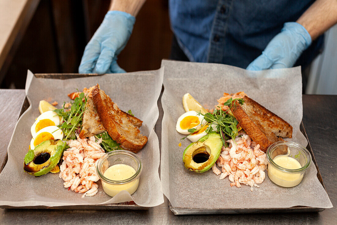 Waiters hands holding freshly prepared food