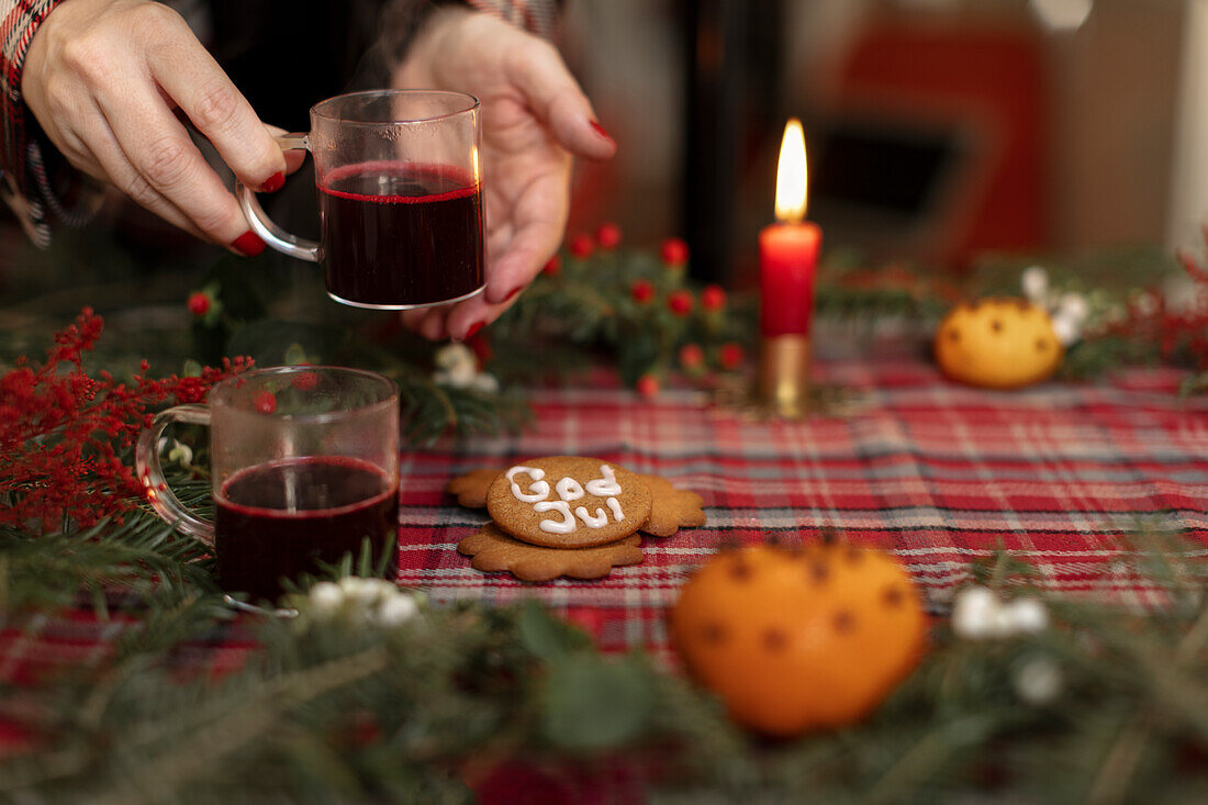 Womans hands holding glass with glogg