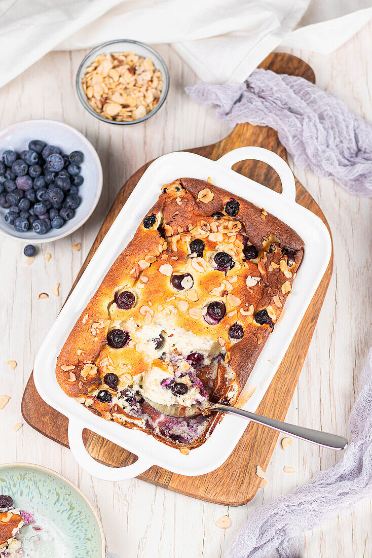 Sweet casserole with ricotta, egg, almonds, and blueberries