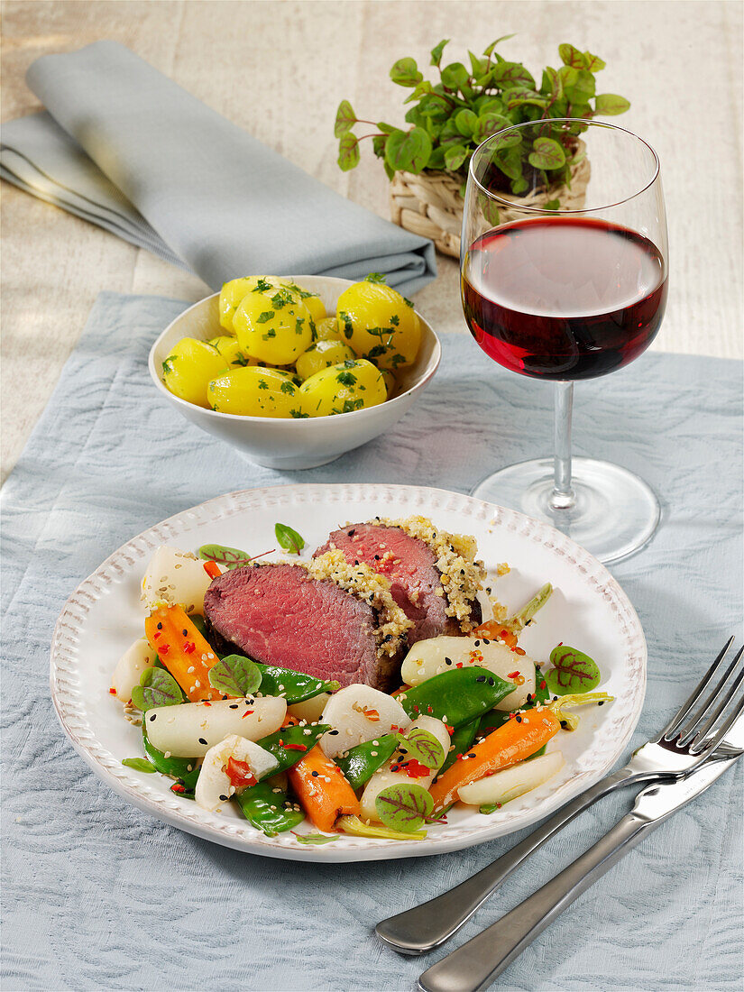 Fillet of beef in a sesame seed crust with spring vegetables