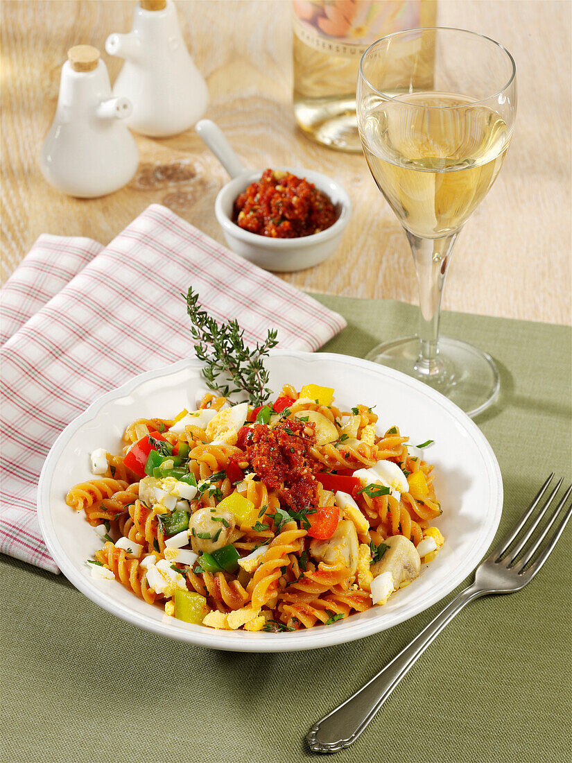 Lentil noodles with hard-boiled eggs, tomato pesto and mushrooms