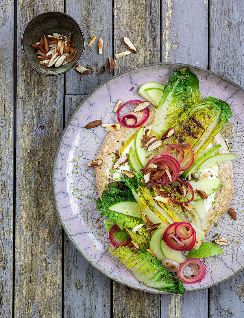 Grilled lettuce with marinated onions and almond cream