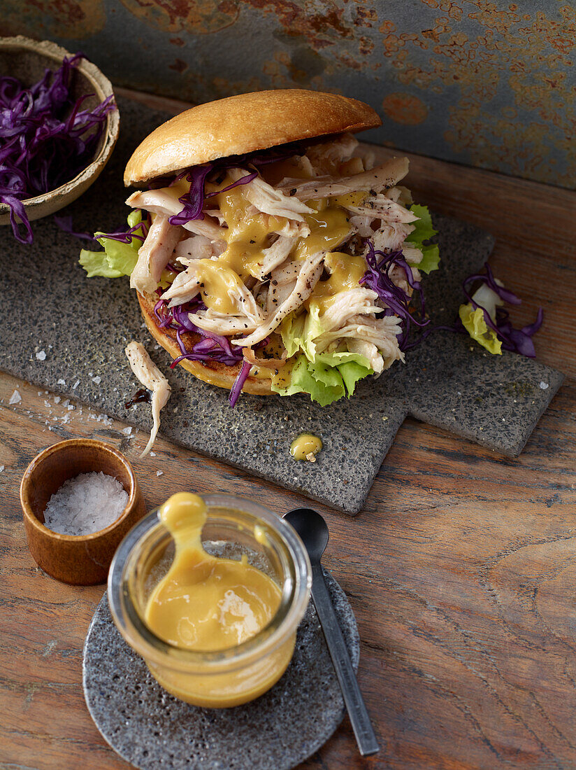 Pulled rabbit with red cabbage and mustard sauce in a brioche bun
