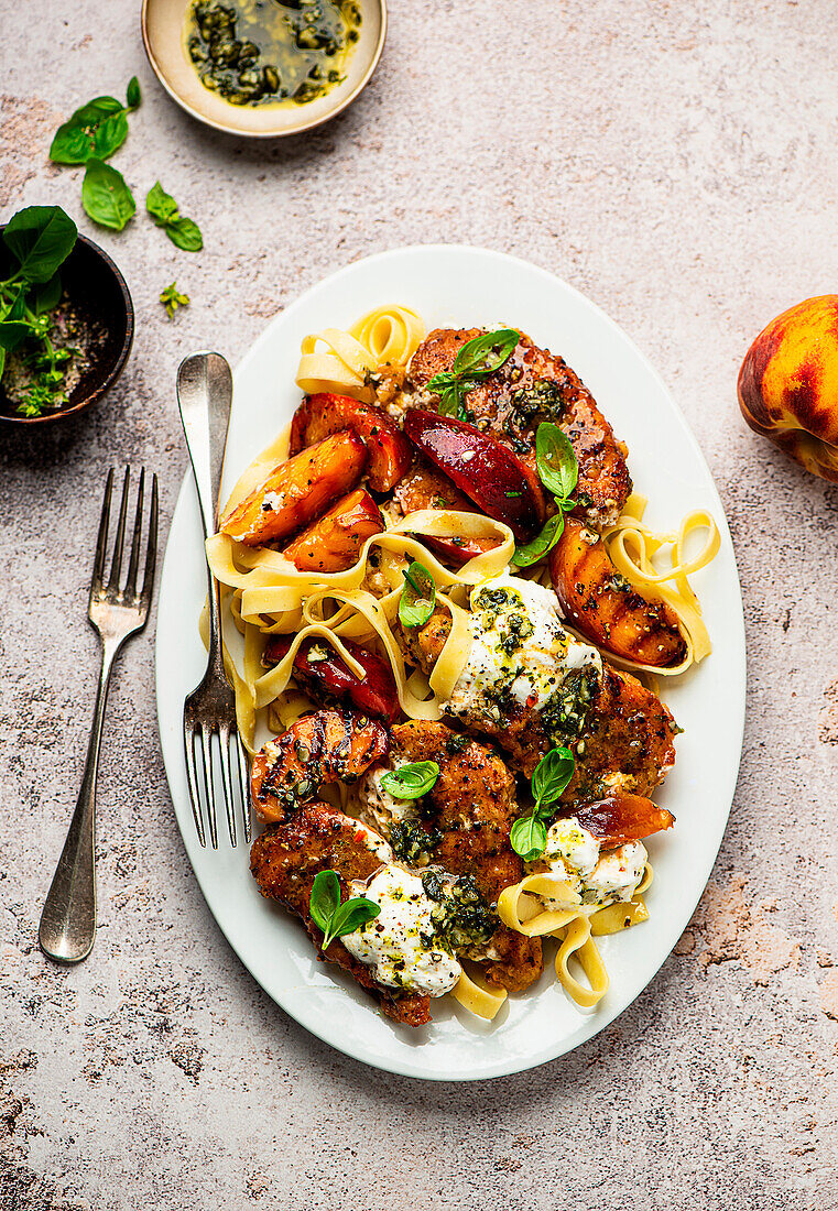 Grilled peaches and chicken with burrata, pesto, and tagliatelle