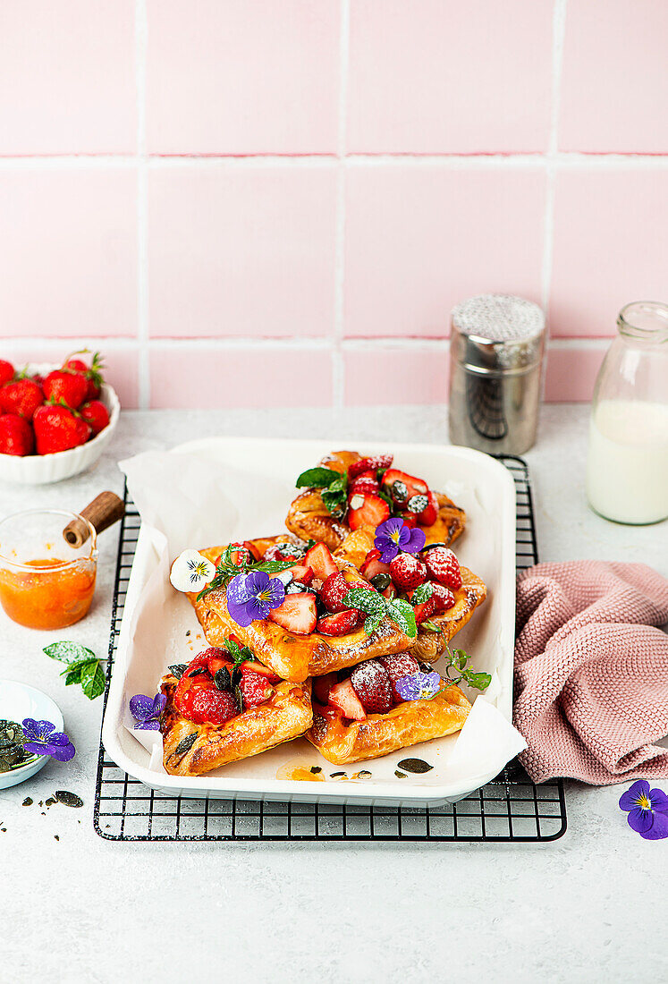 Danish puff pastry with strawberries and edible flowers