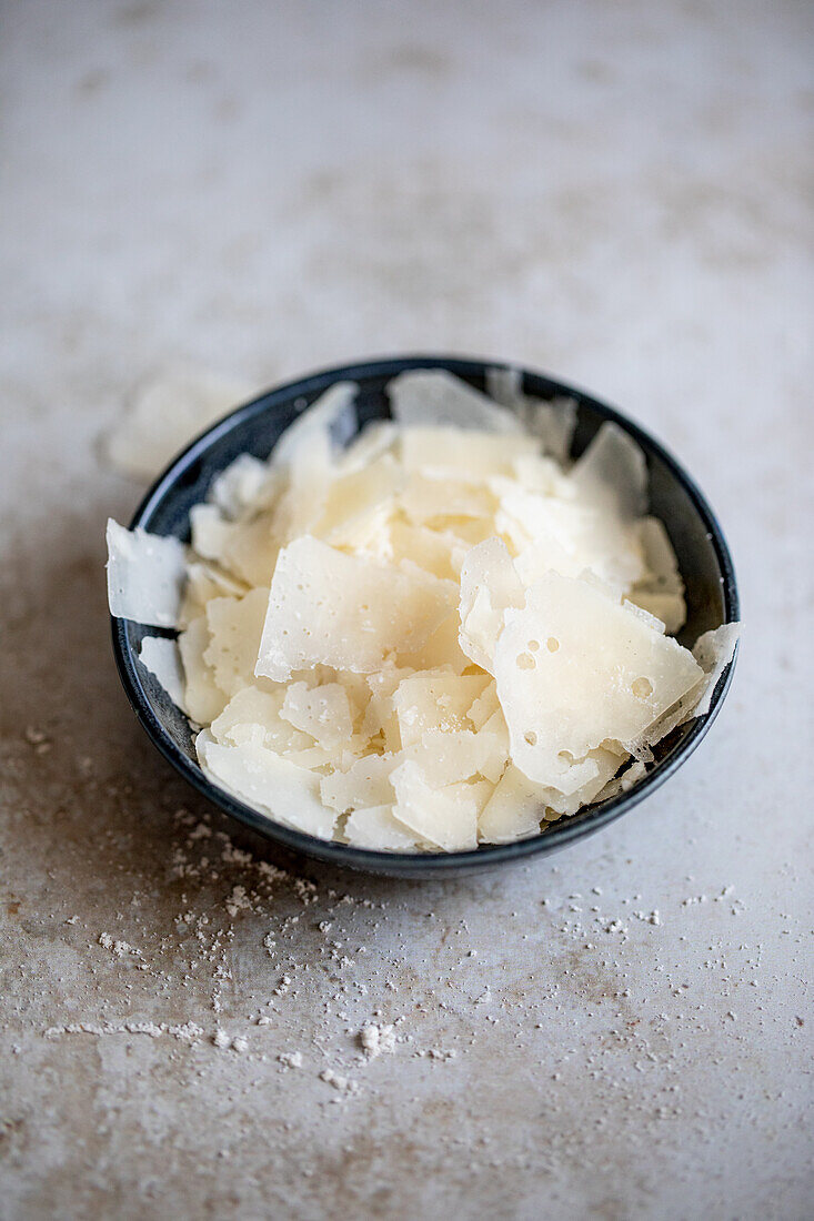 Freshly shaved parmesan in a small bowl