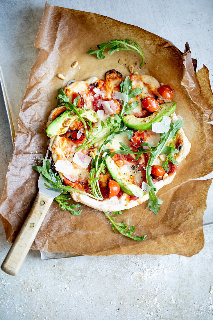 Flatbread with avocado, rocket, parmesan, and pine nuts