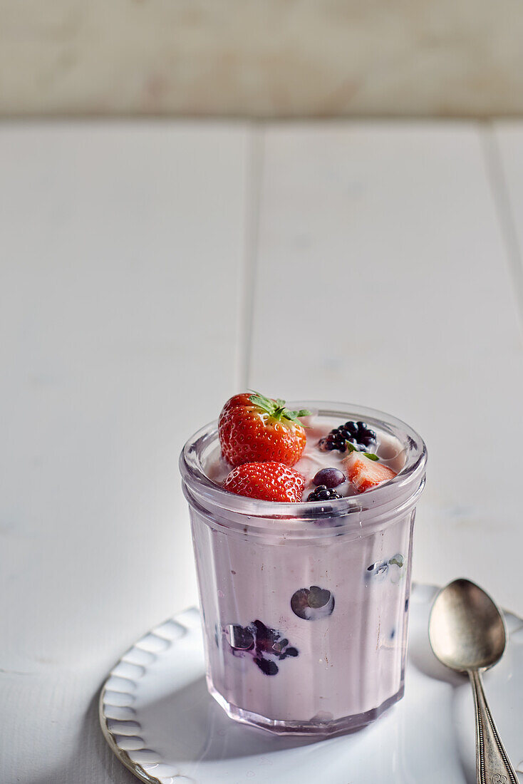 Berry yogurt with fresh strawberries, blueberries, and blackberries