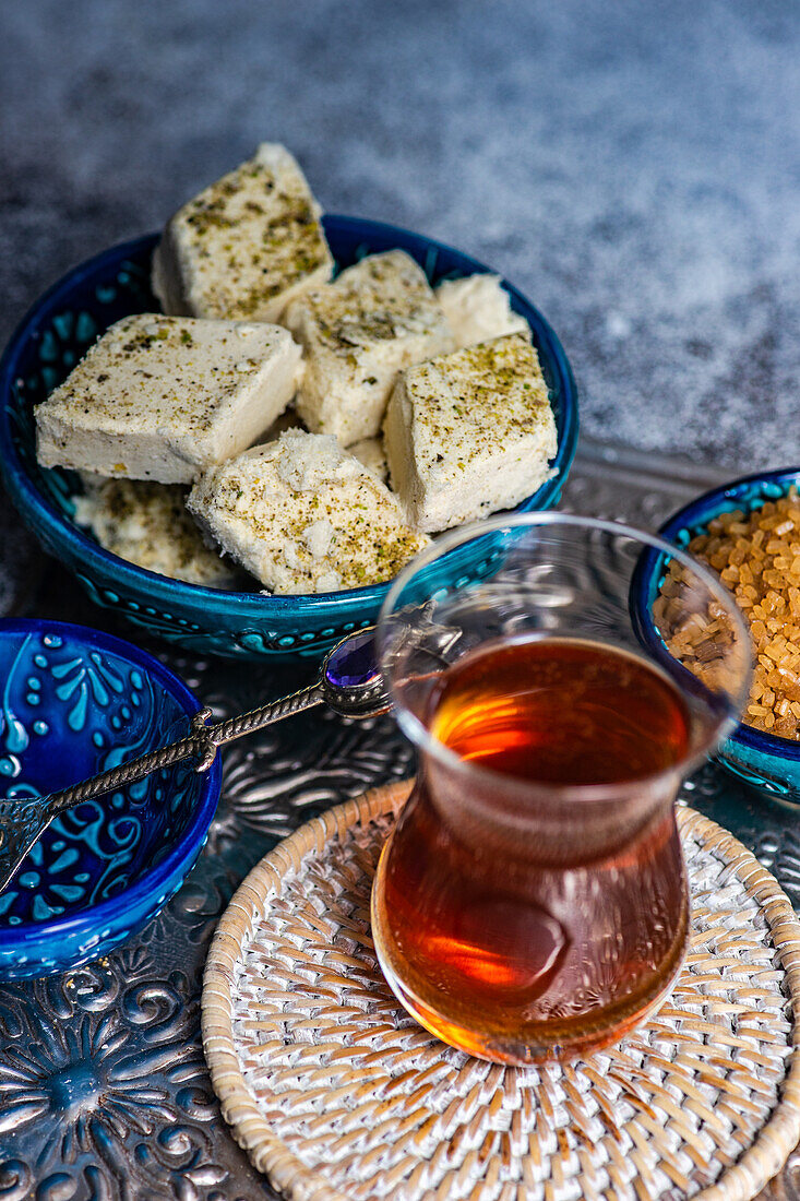 Turkish tea and dessert halva served in traditional style