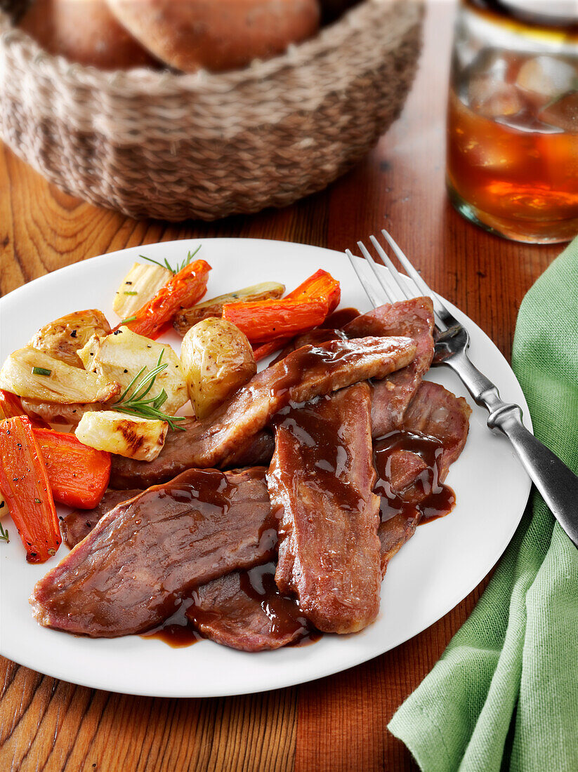 Beef brisket dinner with demi glace, roast potatoes and carrots