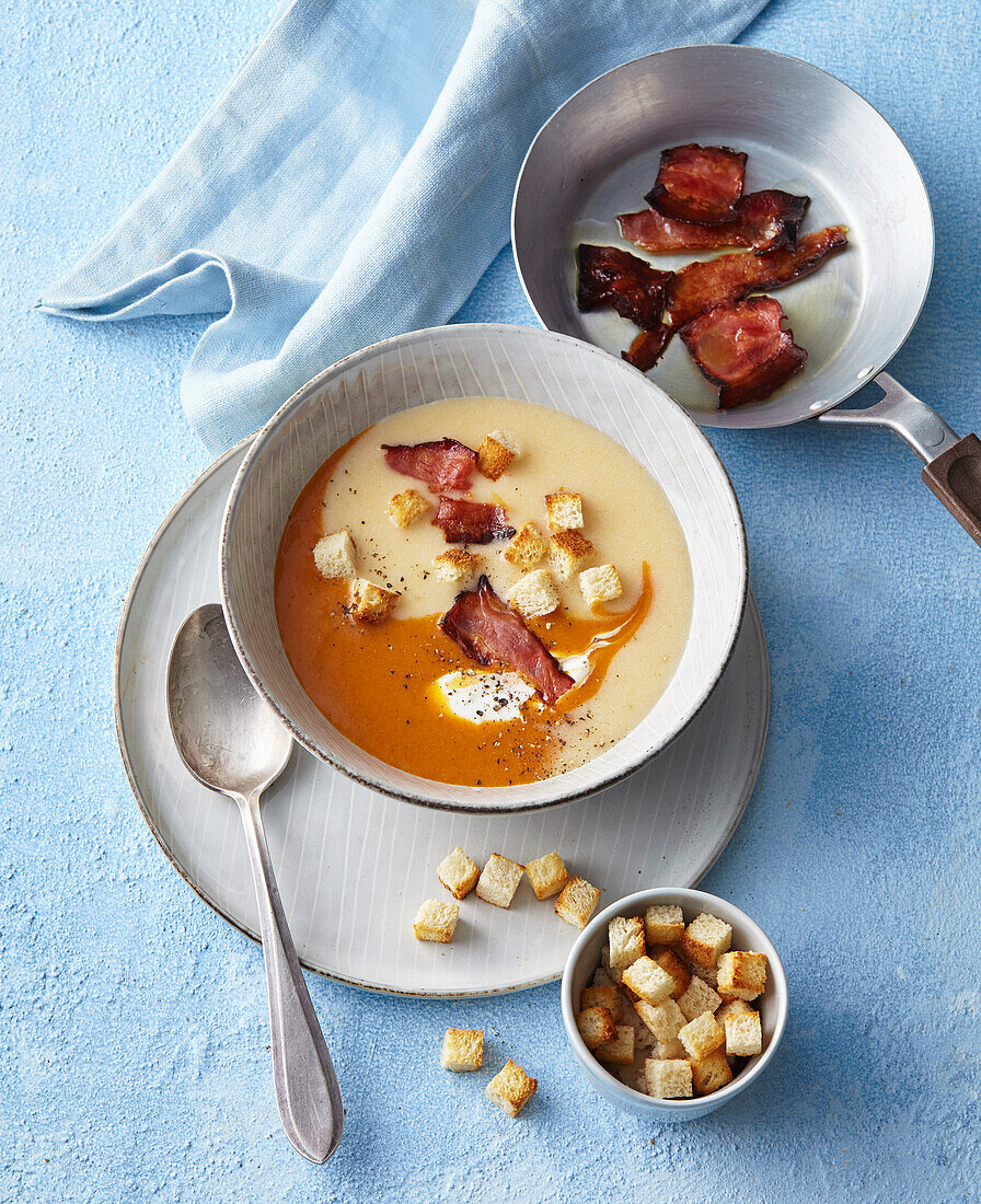 Bicolor pepper creamy soup with bacon and croutons