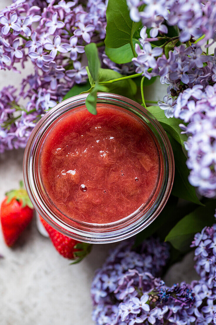 Rhubarb Compote in a jar next to lilac