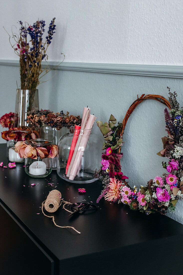 DIY wreaths made of dried flowers and fresh summer flowers and lanterns