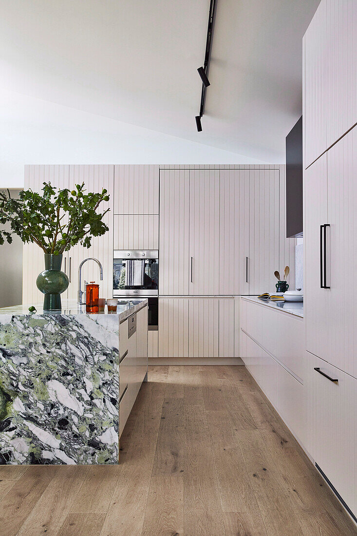 Appliances have been cleverly tucked away behind fold-out doors in the kitchen