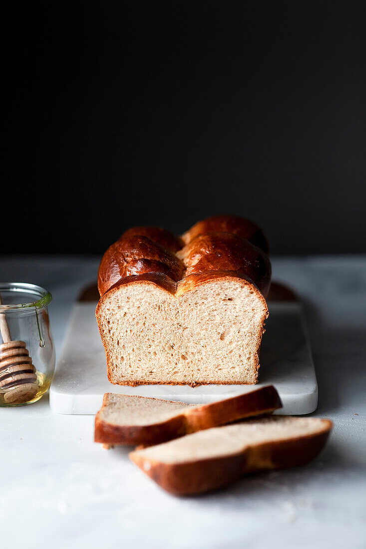 A loaf of sliced brioche bread