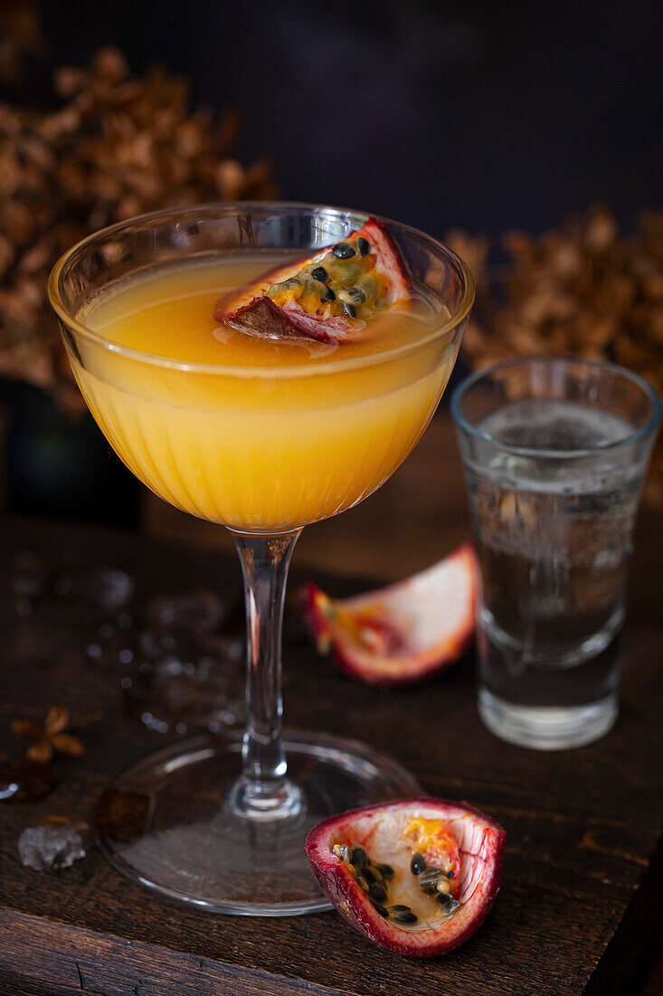 A passionfruit martini (Maverick) topped with a quarter of passion fruit and served with sparkling wine