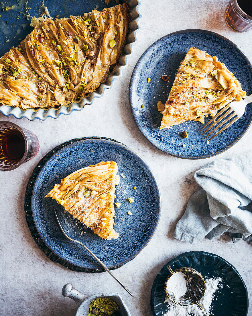 An Egyptian Phyllo Milk Pie (Um Ali) plated on blue dishes