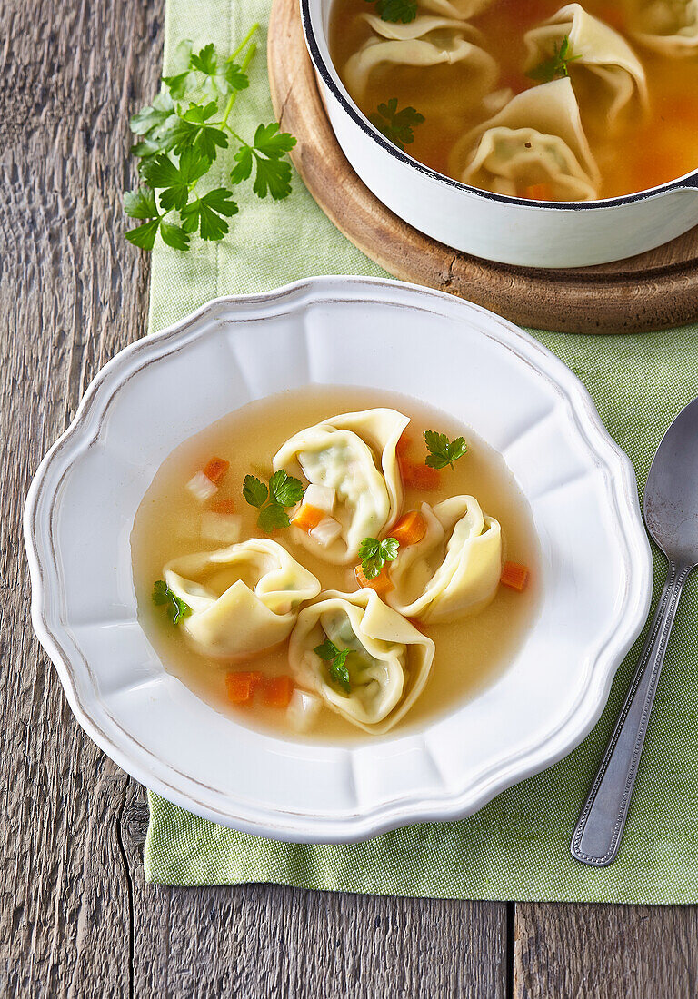 Chicken consomme with ravioli