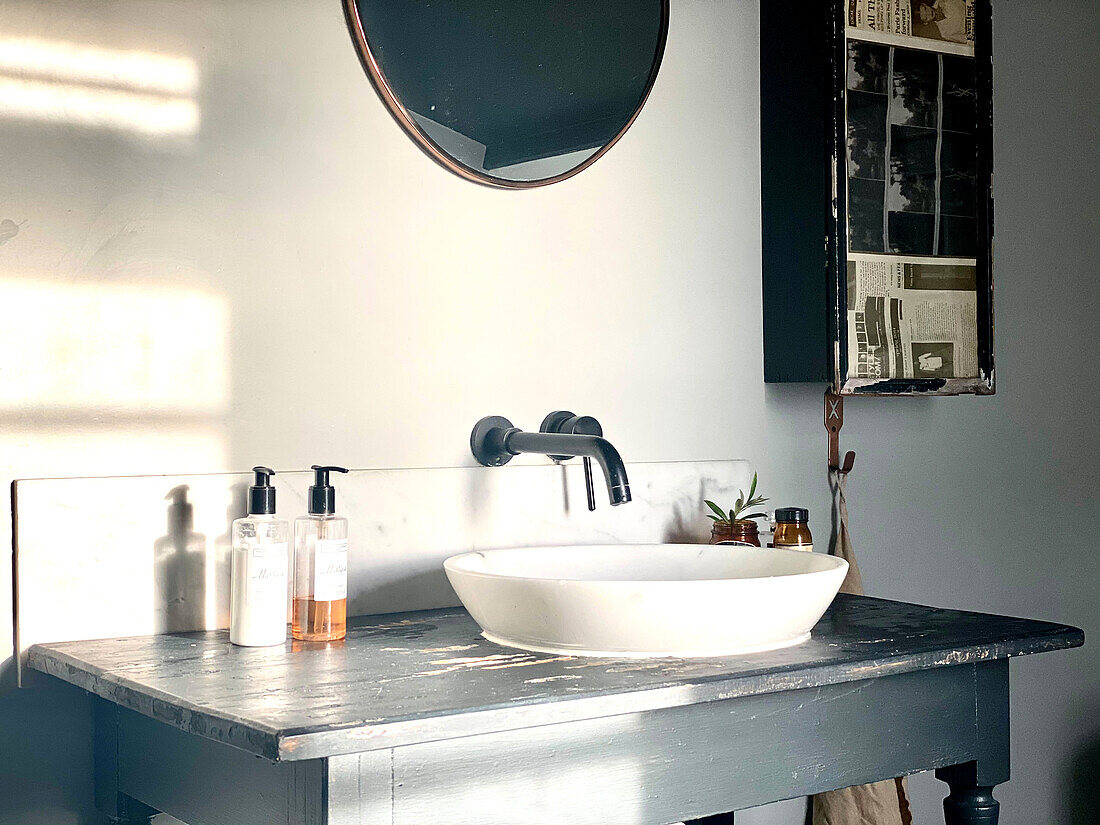 Old table with marble sink in a bathroom