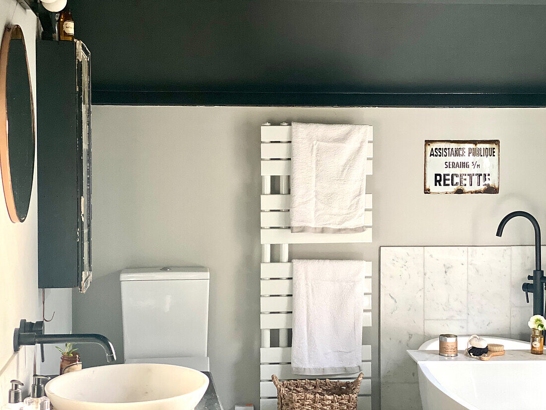 Towel dryer and a vintage sign in a bathroom