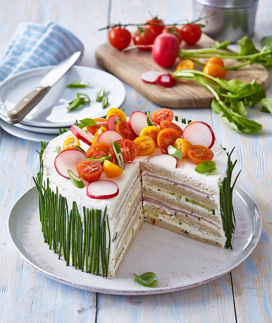 Savoury toast cake with cream cheese and ham, garnished with vegetables
