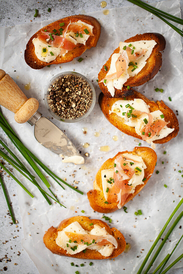 Five rounds of crunchy crostini topped with prosciutto ham, taleggio cheese and chives