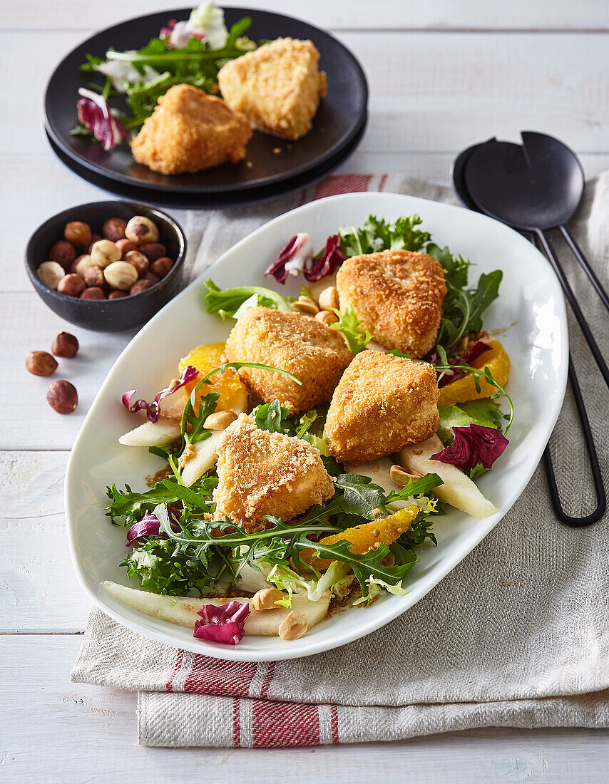 Fried cheese with pear, orange and lettuce salad
