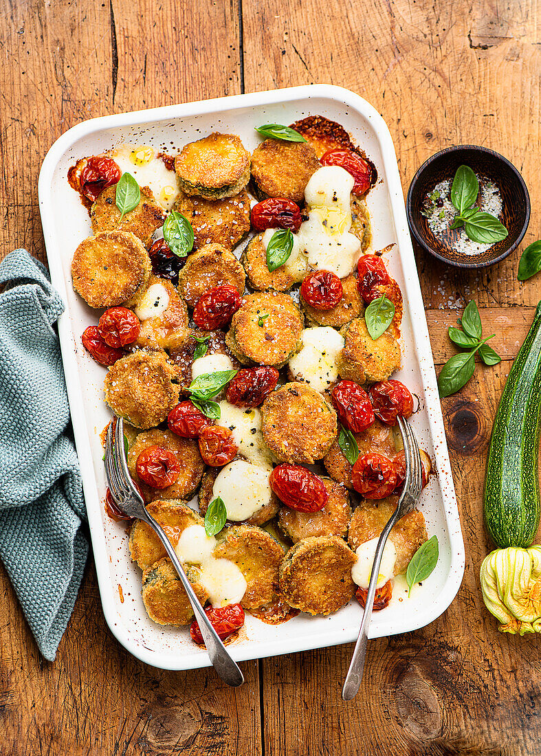 Breaded courgettes with tomatoes and cheese