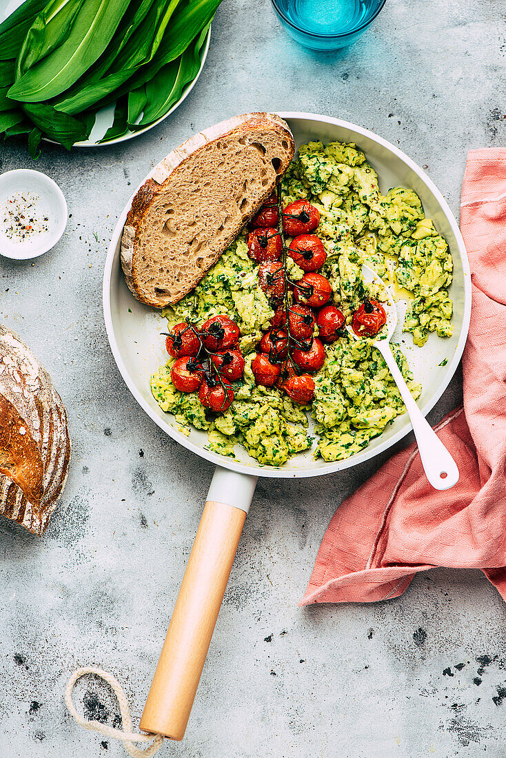 Wild garlic scrambled eggs with oven roasted tomatoes