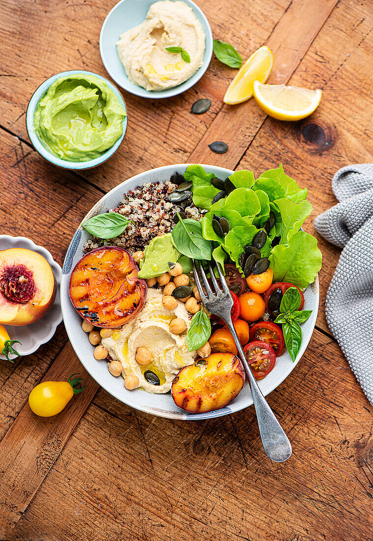 Summer bowl with grilled peaches and hummus