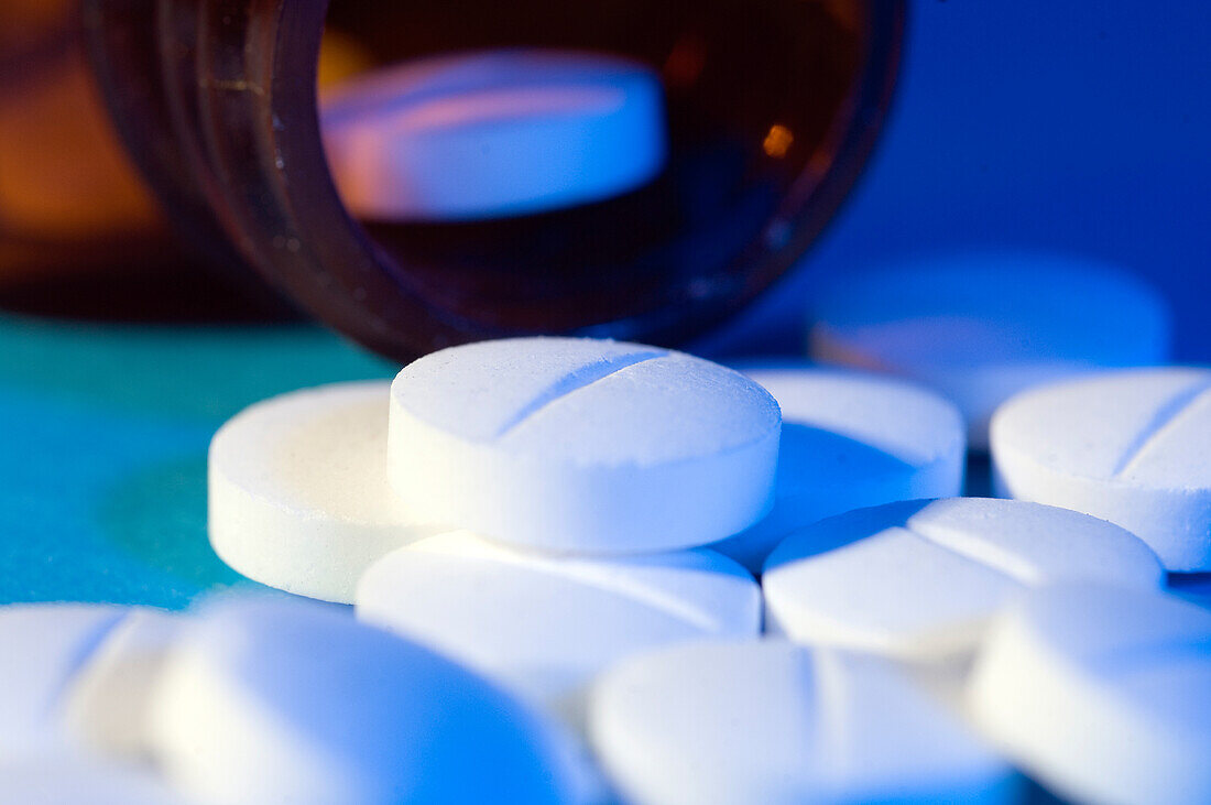Pills spilling from a medicine bottle