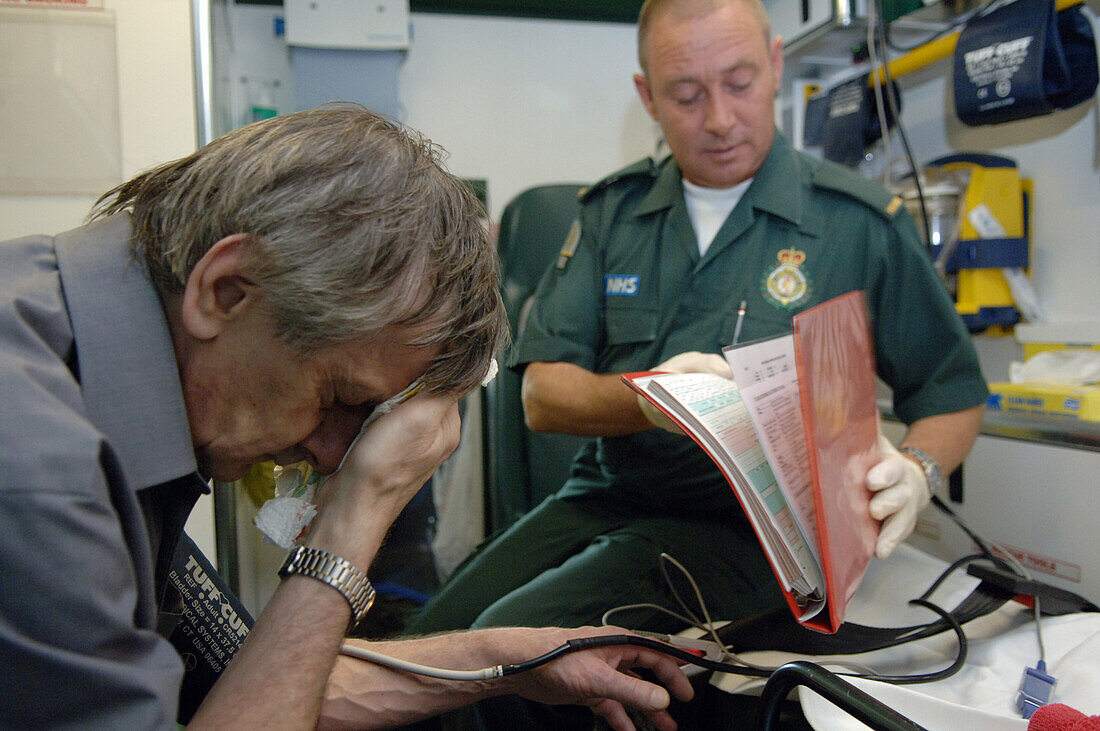 Paramedic taking patients notes