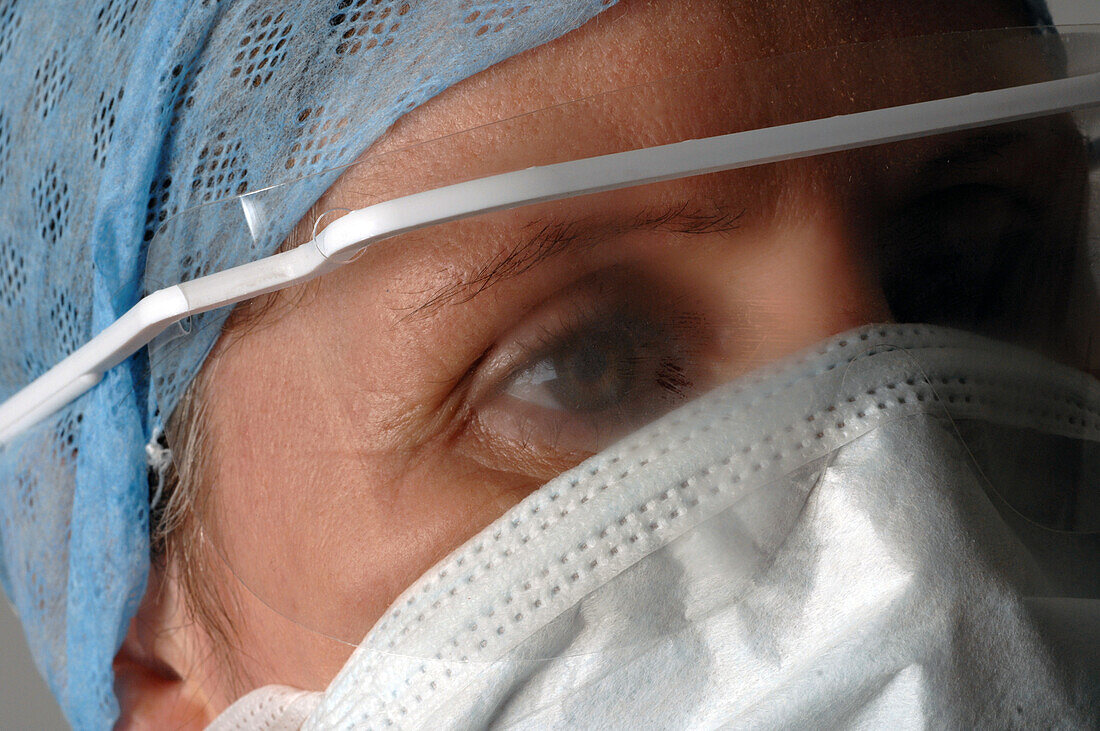 Surgeon wearing an eye shield