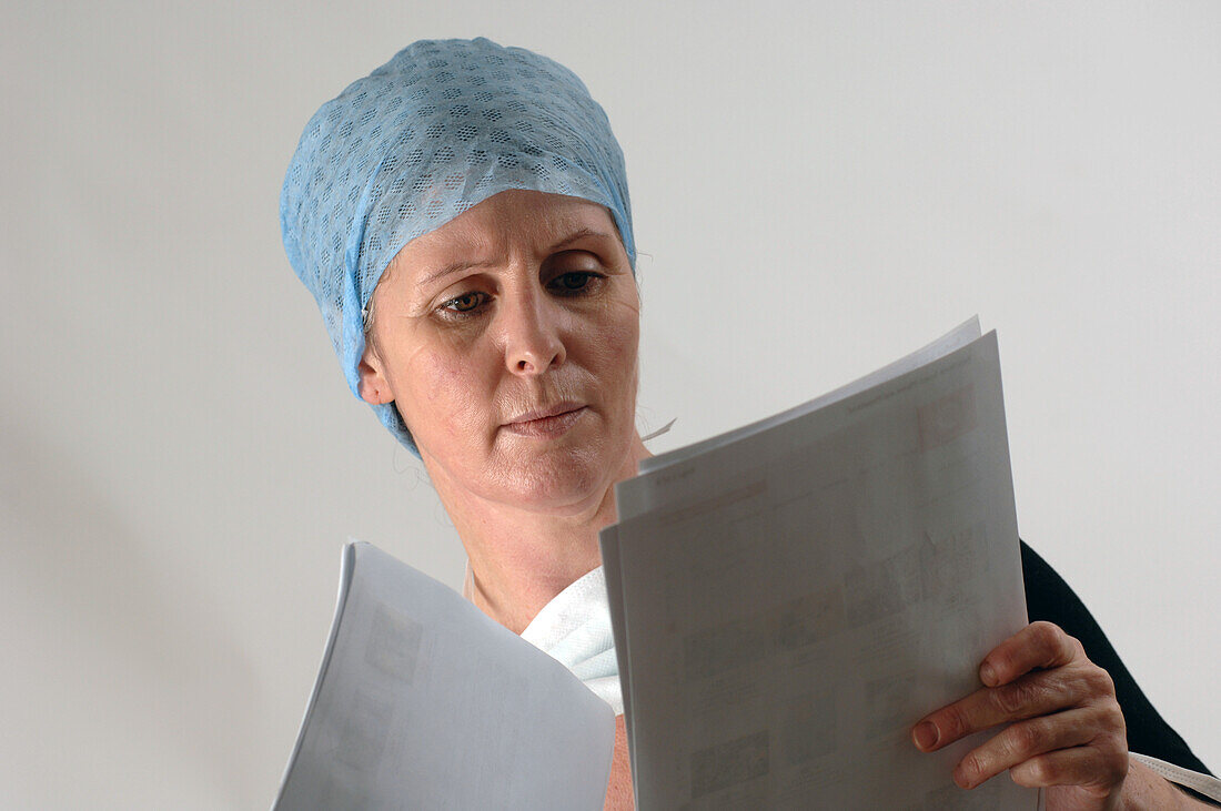 Doctor examining her patient's notes