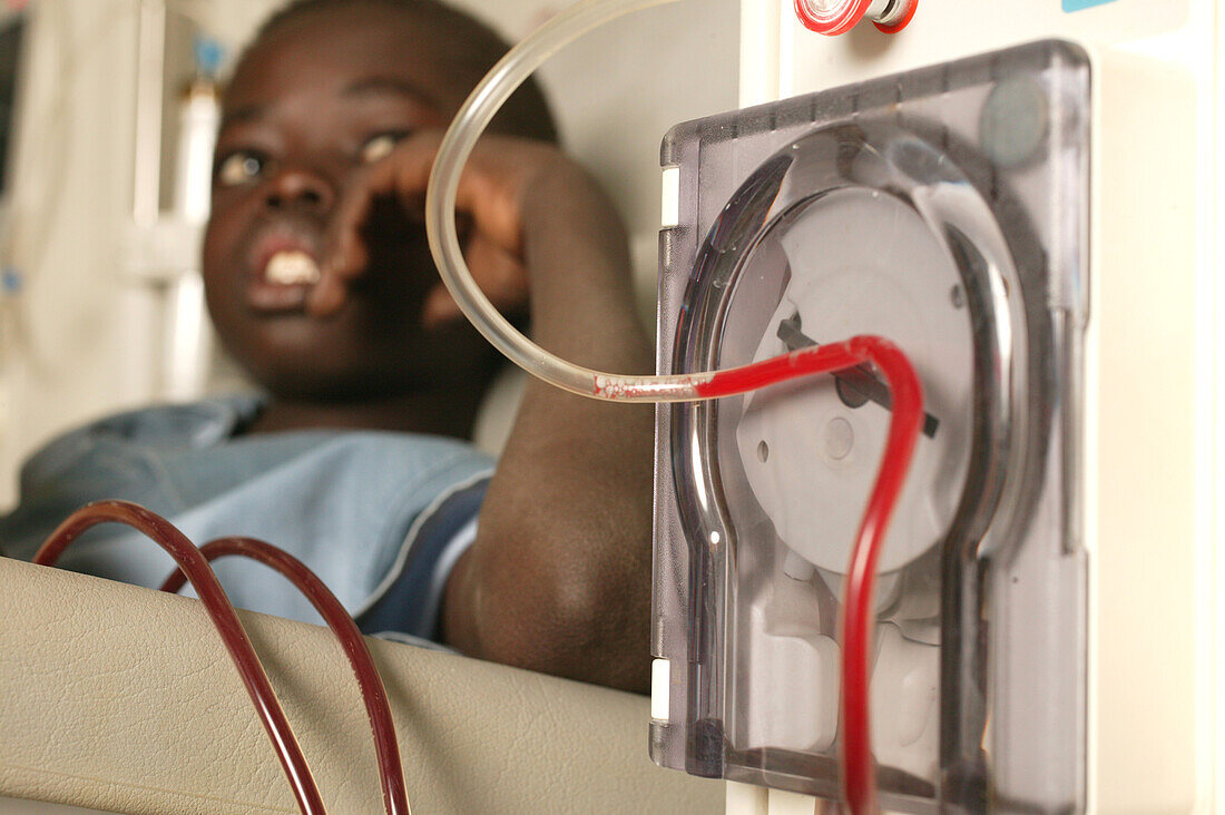 Young boy attached to a dialysis machine