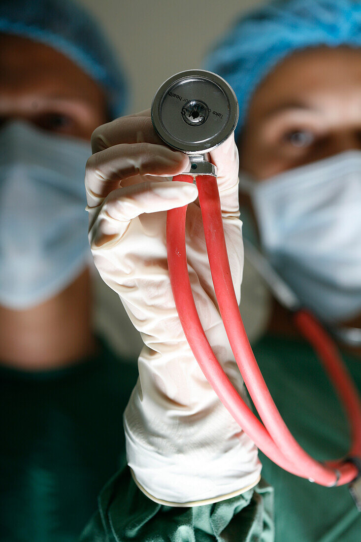 Surgeon stands next to her assistant