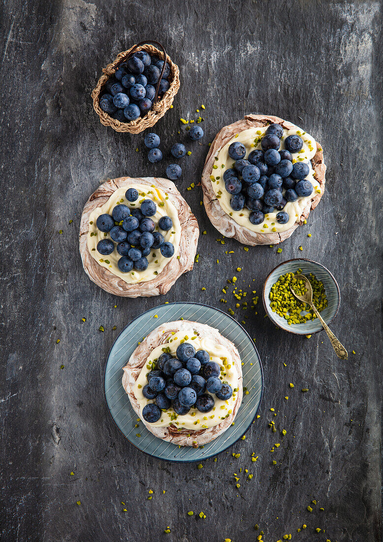 Pavlovas with blueberries, lemon curd and pistachios
