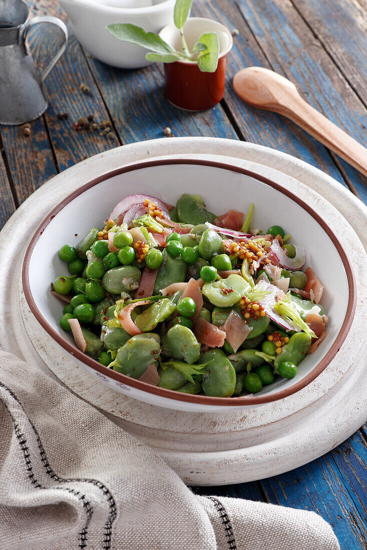 Salad with broad beans, green peas and Parma ham