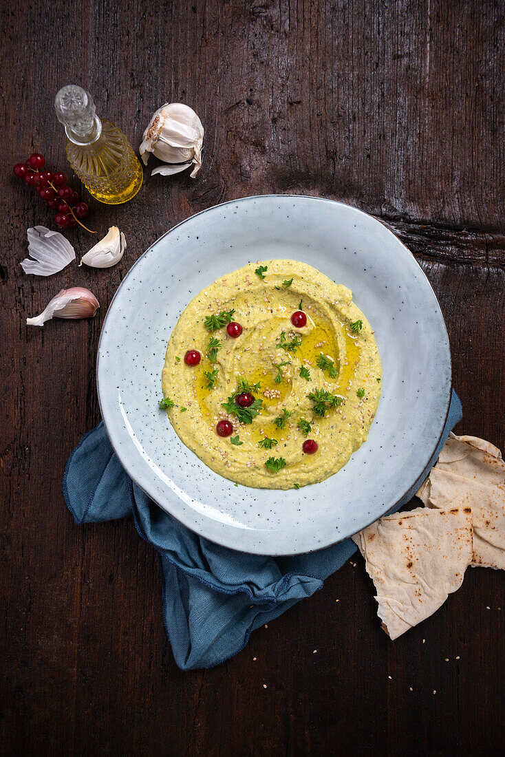 Baba ganoush made with grilled yellow courgette and served with pita bread