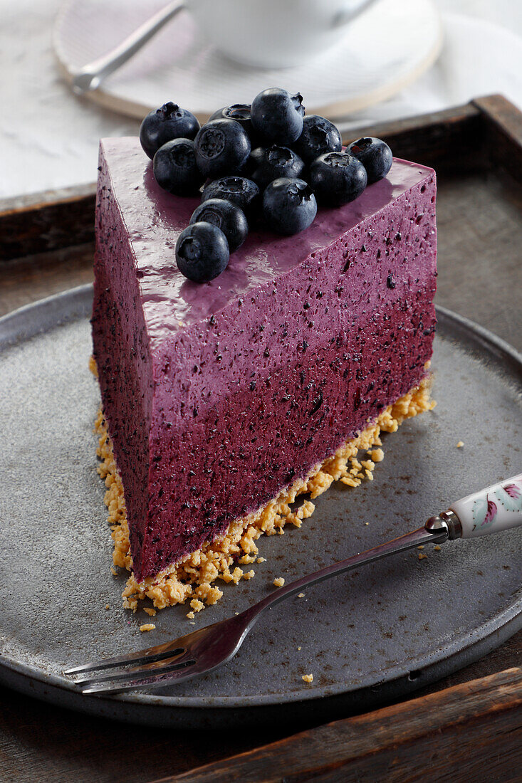 A slice of cream cheese cake with blueberries