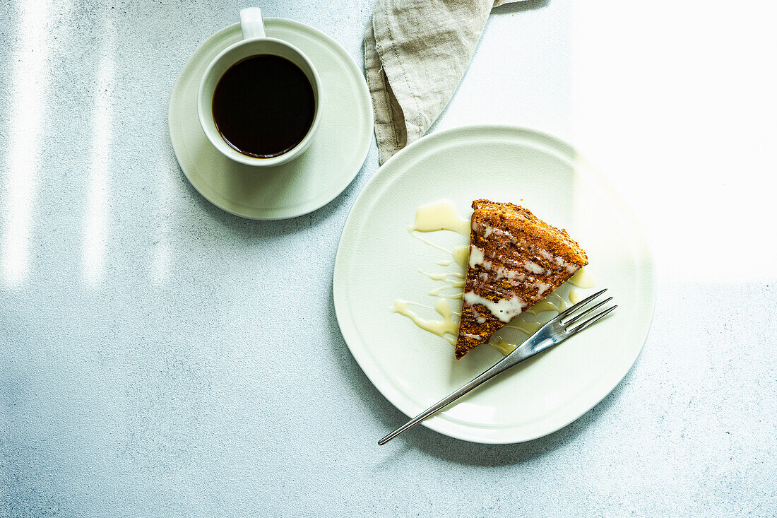 Cup of coffee and slice of honey cake on the table
