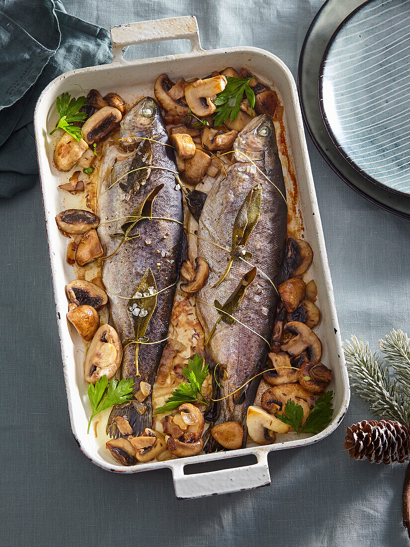 Baked trouts with mushrooms and sage