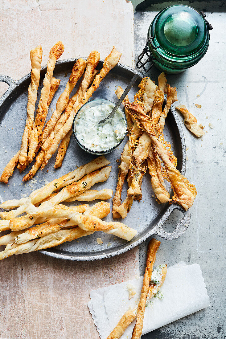 Three types of cheese sticks with a chive dip