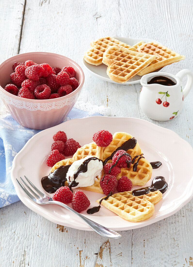 Waffles with raspberries and chocolate glaze