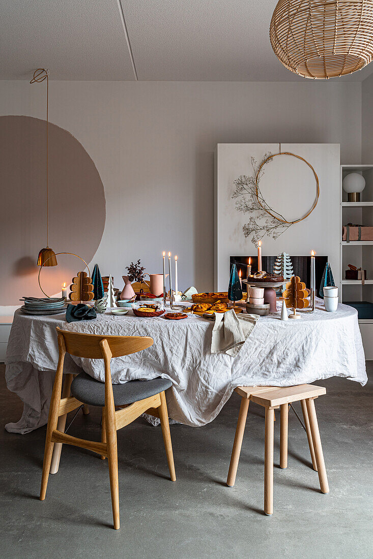 A table decorated for Christmas in a dining room with grey tones