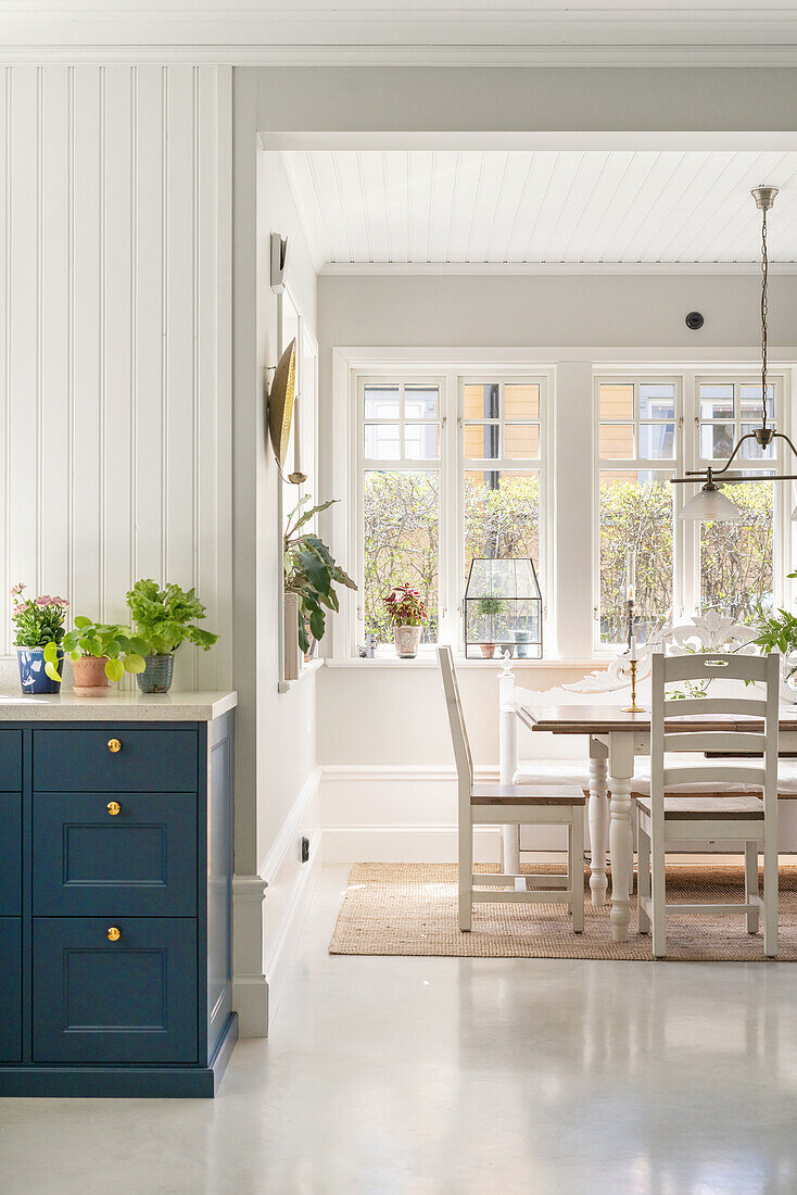 View into bright dining room with large windows