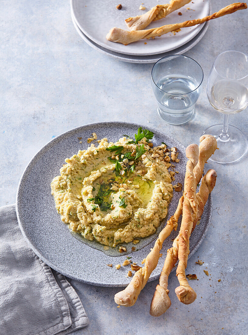 Home baked crostini pizza style with chickpea dip