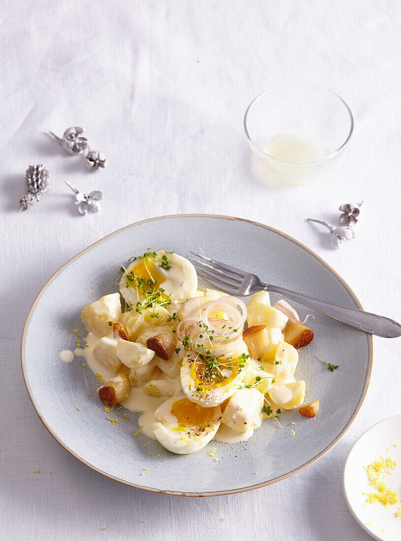 Potato salad with baked garlic and boiled eggs