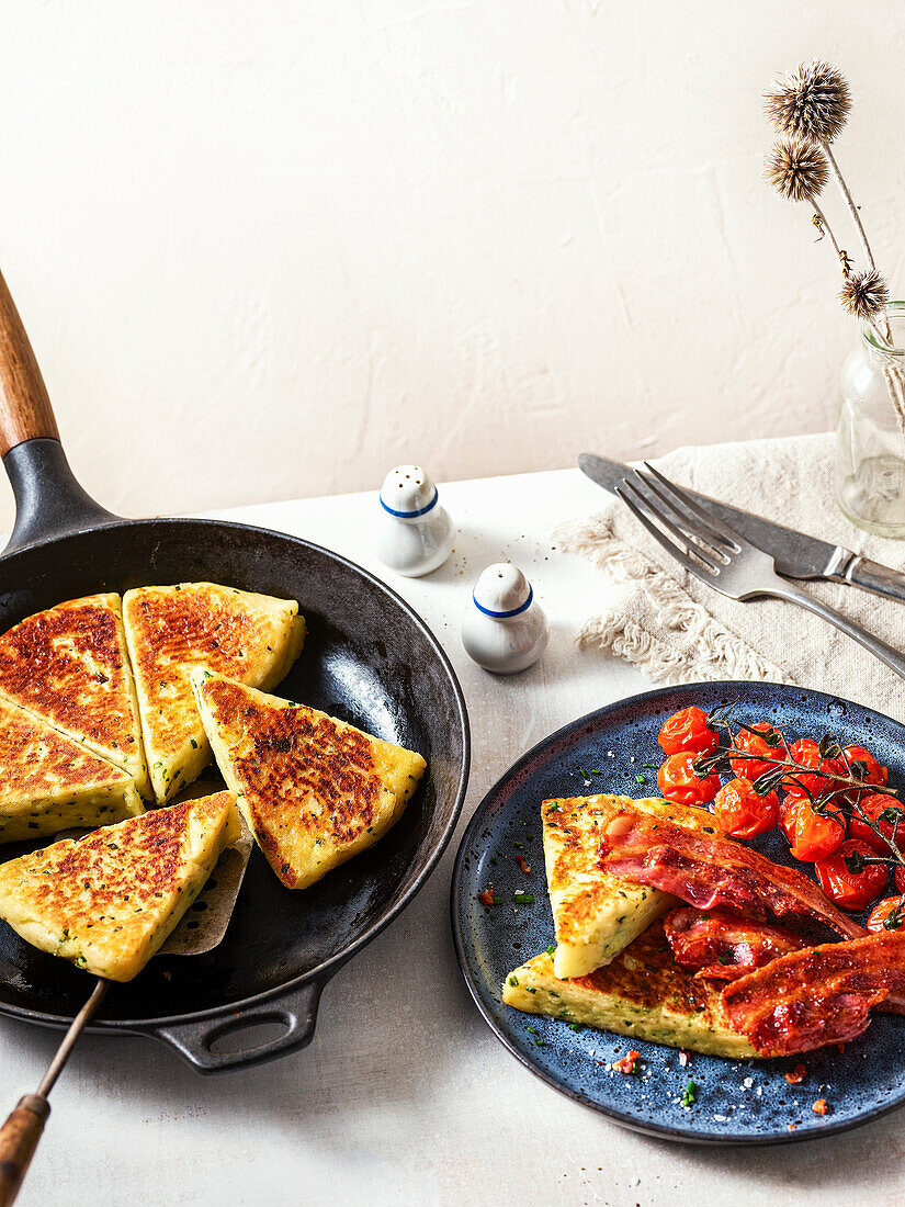 Potato scones with sour cream and chives, served with bacon and tomatoes